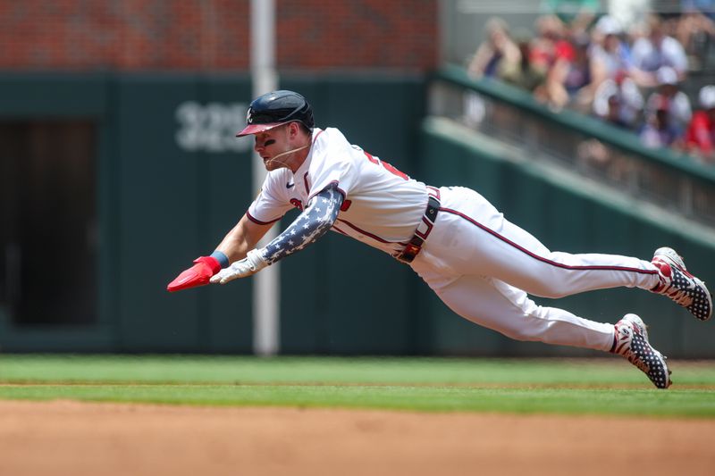 Jul 7, 2024; Atlanta, Georgia, USA; Atlanta Braves center fielder Jarred Kelenic (24) slides safely into second with a stolen base against the Philadelphia Phillies in the first inning at Truist Park. Mandatory Credit: Brett Davis-USA TODAY Sports
