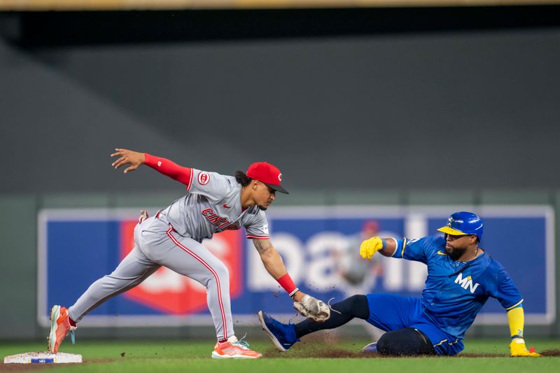 Sep 13, 2024; Minneapolis, Minnesota, USA; Cincinnati Reds second baseman Santiago Espinal (4) tags out Minnesota Twins first baseman Carlos Santana (30) at second base in the seventh inning at Target Field. Mandatory Credit: Jesse Johnson-Imagn Images