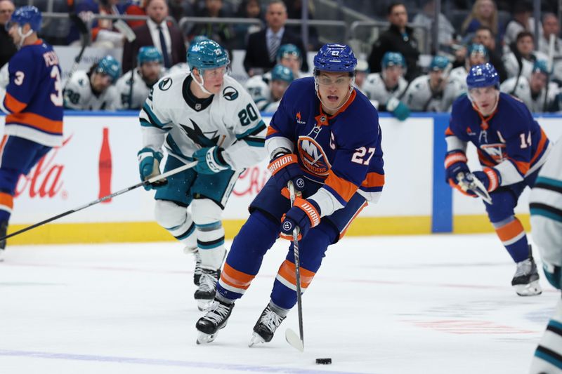 Jan 18, 2025; Elmont, New York, USA; New York Islanders left wing Anders Lee (27) controls the puck up ice against the San Jose Sharks during the second period at UBS Arena. Mandatory Credit: Thomas Salus-Imagn Images