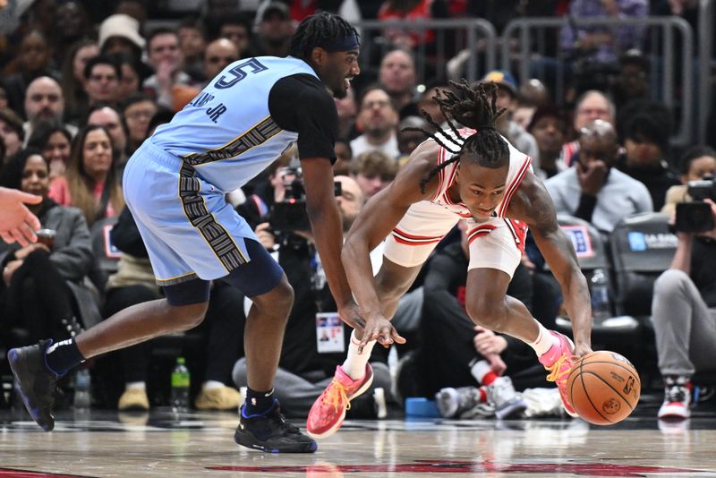 CHICAGO, ILLINOIS - JANUARY 20:  Ayo Dosunmu #12 of the Chicago Bulls is fouled by Vince Williams Jr. #5 of the Memphis Grizzlies after taking control of a loose ball in the first half on January 20, 2024 at the United Center in Chicago, Illinois.   NOTE TO USER: User expressly acknowledges and agrees that, by downloading and or using this photograph, User is consenting to the terms and conditions of the Getty Images License Agreement.  (Photo by Jamie Sabau/Getty Images)