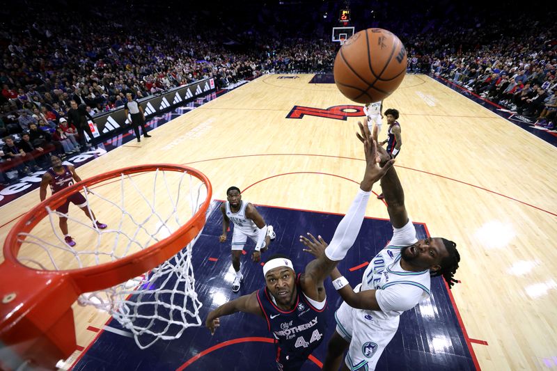 PHILADELPHIA, PENNSYLVANIA - DECEMBER 20: Naz Reid #11 of the Minnesota Timberwolves shoots over Paul Reed #44 of the Philadelphia 76ers during the fourth quarter at the Wells Fargo Center on December 20, 2023 in Philadelphia, Pennsylvania. NOTE TO USER: User expressly acknowledges and agrees that, by downloading and or using this photograph, User is consenting to the terms and conditions of the Getty Images License Agreement. (Photo by Tim Nwachukwu/Getty Images)