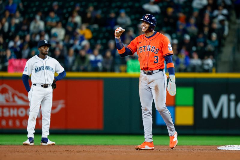 Apr 8, 2025; Seattle, Washington, USA; Houston Astros shortstop Jeremy Peña (3) talks with a member of the Seattle Mariners during the fourth inning at T-Mobile Park. Mandatory Credit: Joe Nicholson-Imagn Images