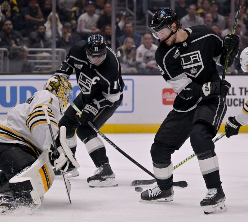 Oct 21, 2023; Los Angeles, California, USA; Los Angeles Kings center Anze Kopitar (11) takes a shot against Boston Bruins goaltender Jeremy Swayman (1) with center Adrian Kempe (right) during the second period at Crypto.com Arena. Mandatory Credit: Alex Gallardo-USA TODAY Sports