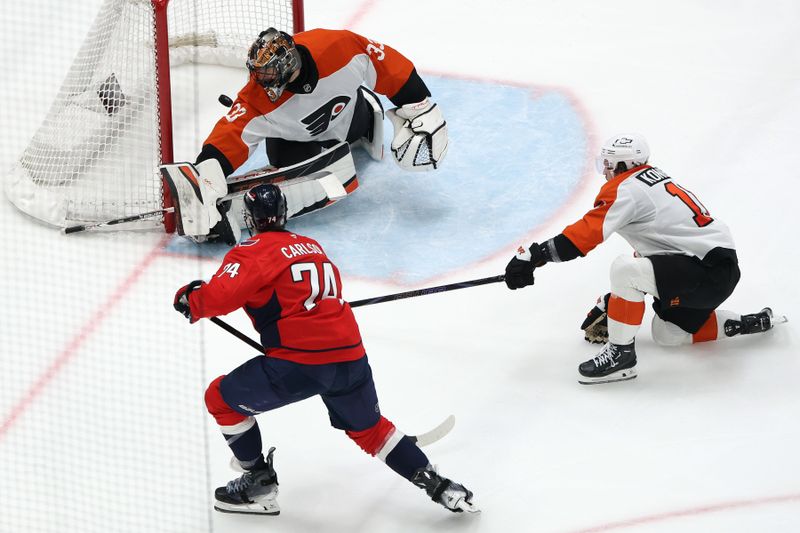 Mar 20, 2025; Washington, District of Columbia, USA; Washington Capitals defenseman John Carlson (74) scores a goal past Philadelphia Flyers goaltender Samuel Ersson (33) that was eventually overturned during the third period against at Capital One Arena. Mandatory Credit: Daniel Kucin Jr.-Imagn Images