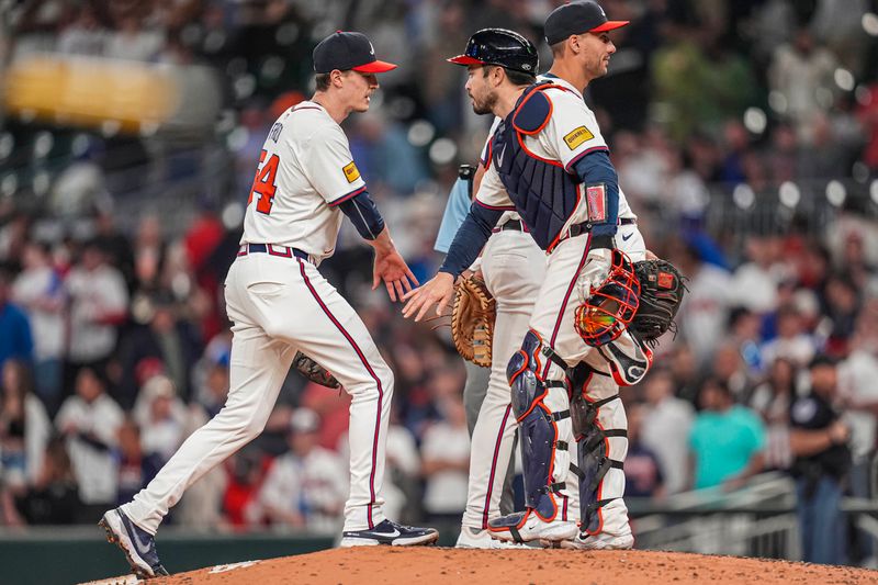 Apr 23, 2024; Cumberland, Georgia, USA; Atlanta Braves pitcher Max Fried (54) reacts with catcher Travis d'Arnaud (16) after pitching a complete game shutout against the Miami Marlins at Truist Park. Mandatory Credit: Dale Zanine-USA TODAY Sports