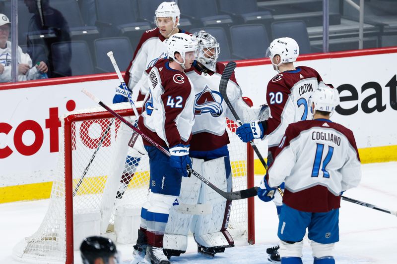 Apr 23, 2024; Winnipeg, Manitoba, CAN; Colorado Avalanche goalie Alexander Georgiev (40) is congratulated by his teammates on the win against the Winnipeg Jets at the end of the third period in game two of the first round of the 2024 Stanley Cup Playoffs at Canada Life Centre. Mandatory Credit: Terrence Lee-USA TODAY Sports