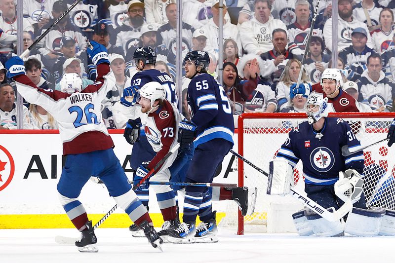 Apr 30, 2024; Winnipeg, Manitoba, CAN; Colorado Avalanche center Yakov Trenin (73) scores on Winnipeg Jets goaltender Connor Hellebuyck (37) in the second period in game five of the first round of the 2024 Stanley Cup Playoffs at Canada Life Centre. Mandatory Credit: James Carey Lauder-USA TODAY Sports