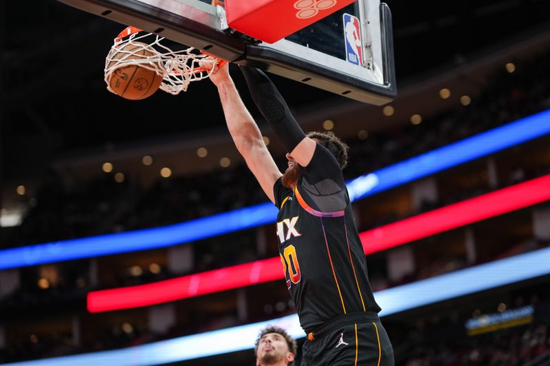 HOUSTON, TEXAS - DECEMBER 27: Jusuf Nurkic #20 of the Phoenix Suns dunks the ball during the second quarter of the game against the Houston Rockets  at Toyota Center on December 27, 2023 in Houston, Texas. User expressly acknowledges and agrees that, by downloading and or using this photograph, User is consenting to the terms and conditions of the Getty Images License Agreement. (Photo by Alex Bierens de Haan/Getty Images)