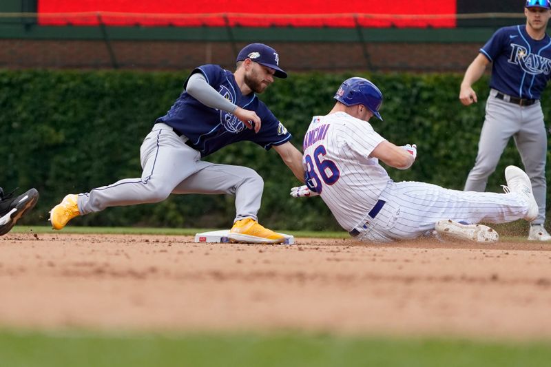 May 31, 2023; Chicago, Illinois, USA; Chicago Cubs first baseman Trey Mancini (36) is tagged out at second base by Tampa Bay Rays second baseman Brandon Lowe (8) during the seventh inning at Wrigley Field. Mandatory Credit: David Banks-USA TODAY Sports