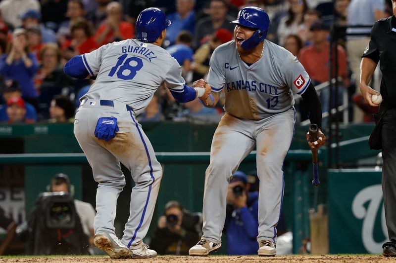 Sep 25, 2024; Washington, District of Columbia, USA; Kansas City Royals catcher Salvador Perez (13) and Royals first baseman Yuli Gurriel (18) celebrate at home plate after scoring runs on a two run single by Royals outfielder Robbie Grossman (not pictured) against the Washington Nationals during the sixth inning at Nationals Park. Mandatory Credit: Geoff Burke-Imagn Images