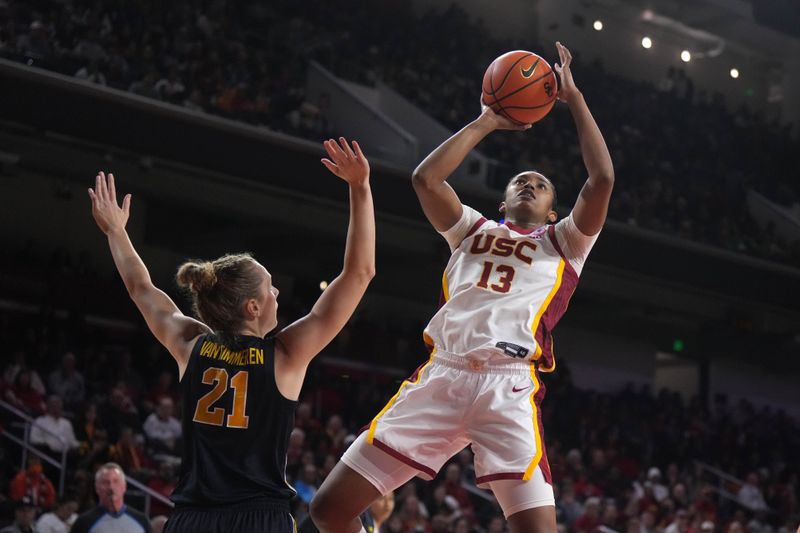 Dec 29, 2024; Los Angeles, California, USA; Southern California Trojans center Rayah Marshall (13) shoots the ball against Michigan Wolverines forward Ally VanTimmeren (21) in the first half at Galen Center. Mandatory Credit: Kirby Lee-Imagn Images