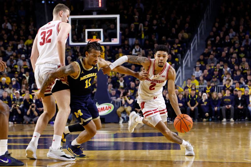 Jan 10, 2026; Ann Arbor, Michigan, USA;  Wisconsin Badgers guard Nick Boyd (2) dribbles defended by Michigan Wolverines guard Roddy Gayle Jr. (11) in the second half at Crisler Center. Mandatory Credit: Rick Osentoski-Imagn Images