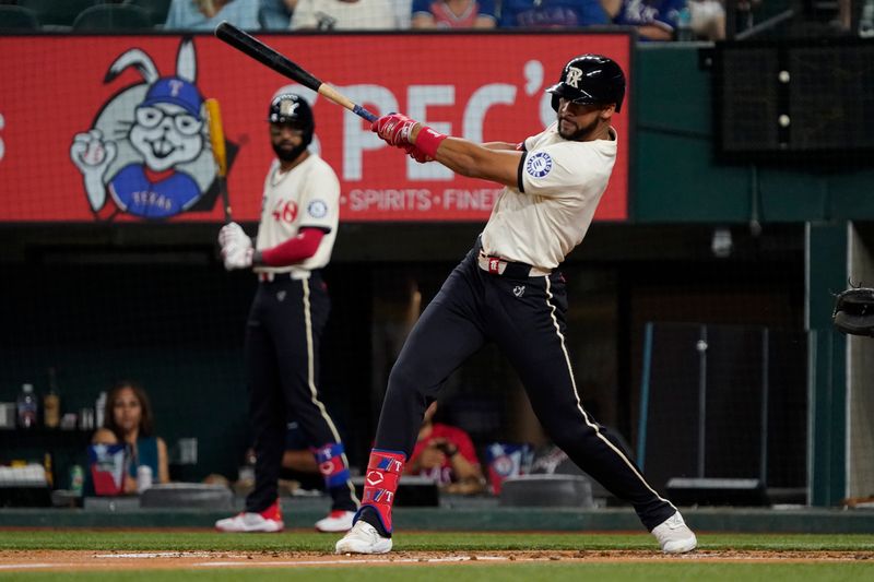 Jul 5, 2024; Arlington, Texas, USA; Texas Rangers outfielder Leody Taveras (3) hits a single during the third inning against the Tampa Bay Rays at Globe Life Field. Mandatory Credit: Raymond Carlin III-USA TODAY Sports