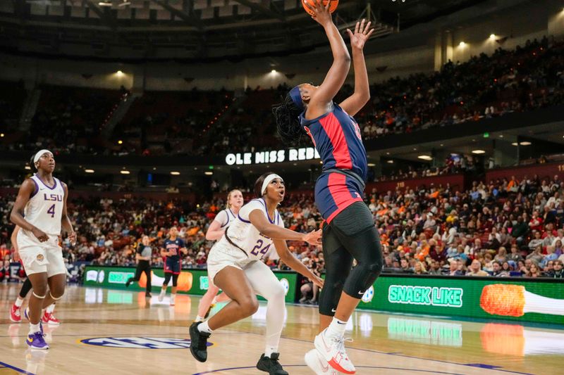 Mar 9, 2024; Greensville, SC, USA; Ole Miss Rebels center Rita Igbokwe (32) shoots a layup against LSU Lady Tigers guard Aneesah Morrow (24) during the first half at Bon Secours Wellness Arena. Mandatory Credit: Jim Dedmon-USA TODAY Sports