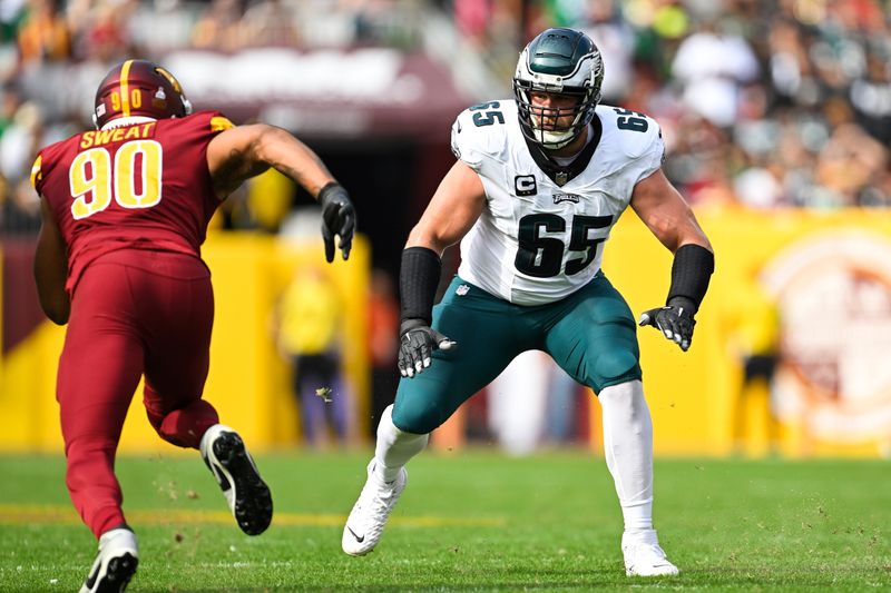 Philadelphia Eagles offensive tackle Lane Johnson (65) in action Washington Commanders defensive end Montez Sweat (90) during the first half of an NFL football game, Sunday, Oct. 29, 2023, in Landover, Md. (AP Photo/Terrance Williams)