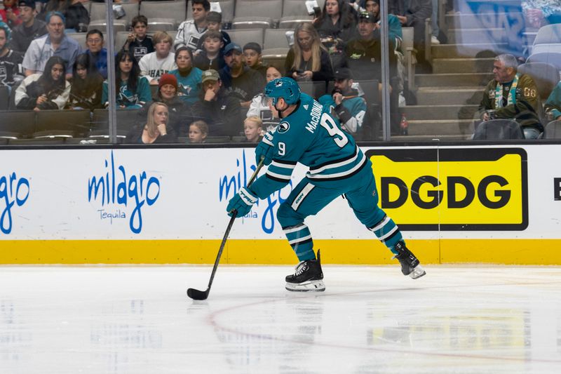 Dec 19, 2023; San Jose, California, USA; San Jose Sharks defenseman Jacob MacDonald (9) passes the puck during the first period against the Los Angeles Kings at SAP Center at San Jose. Mandatory Credit: Neville E. Guard-USA TODAY Sports