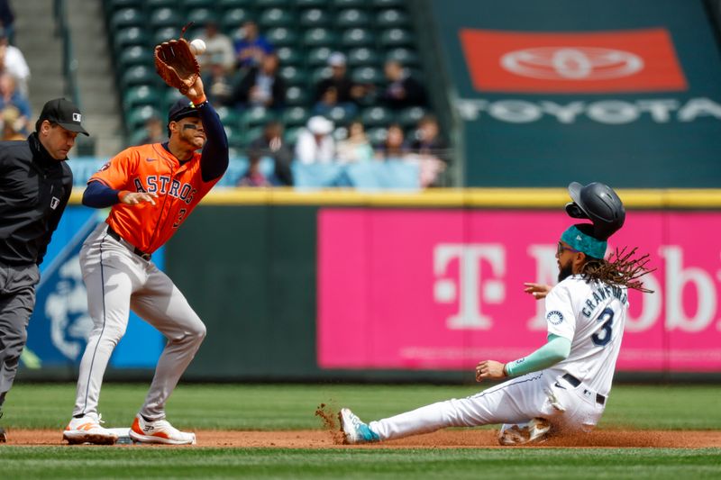 May 30, 2024; Seattle, Washington, USA; Seattle Mariners shortstop J.P. Crawford (3) steals second base before Houston Astros shortstop Jeremy Pena (3) can apply a tag during the first inning at T-Mobile Park. Mandatory Credit: Joe Nicholson-USA TODAY Sports