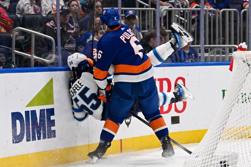 Mar 23, 2024; Elmont, New York, USA;  New York Islanders defenseman Ryan Pulock (6) checks Winnipeg Jets center Mark Scheifele (55) into the boards during the first period at UBS Arena. Mandatory Credit: Dennis Schneidler-USA TODAY Sports