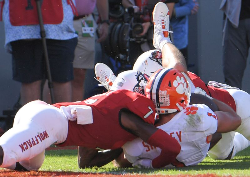 Oct 28, 2023; Raleigh, North Carolina, USA; Clemson Tigers running back Will Shipley (1) is hit by North Carolina State Wolfpack cornerback Shyheim Battle (7) near the goal line during the second quarter at Carter-Finley Stadium. Mandatory Credit: Ken Ruinard-USA TODAY Sports