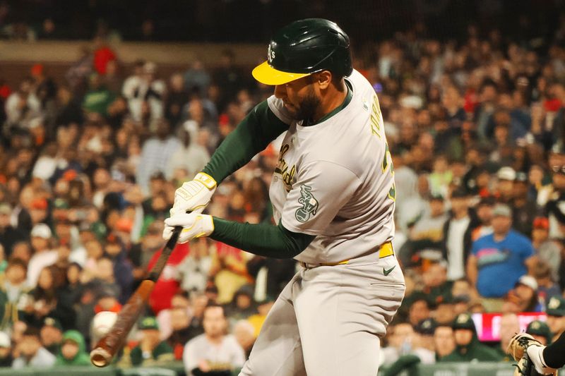 Jul 31, 2024; San Francisco, California, USA; Oakland Athletics third baseman Abraham Toro (31) hits a single against the San Francisco Giants during the ninth inning at Oracle Park. Mandatory Credit: Kelley L Cox-USA TODAY Sports