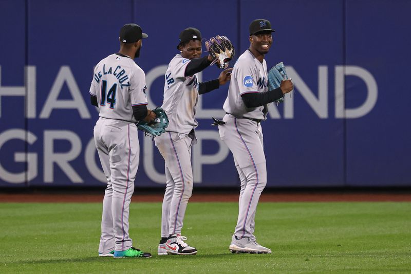 Sep 27, 2023; New York, NY, USA; Miami Marlins left fielder Bryan De La Cruz (14) celebrates with center fielder Jazz Chisholm Jr. (2) and left fielder Bryan De La Cruz (14) after defeating the New York Mets at Citi Field.  Mandatory Credit: Vincent Carchietta-USA TODAY Sports