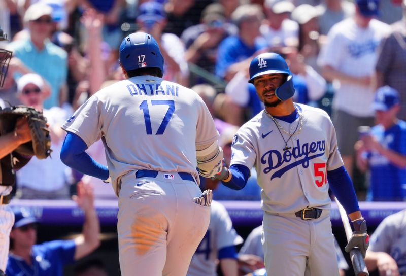 Jun 26, 2025; Denver, Colorado, USA; Los Angeles Dodgers shortstop Mookie Betts (50) congratulates designated hitter Shohei Ohtani (17) after his solo home run  in the seventh inning at Coors Field. Mandatory Credit: Ron Chenoy-Imagn Images