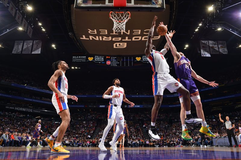 PHOENIX, AZ - FEBRUARY 14:  Drew Eubanks #14 of the Phoenix Suns and Jalen Duren #0 of the Detroit Pistons battle for a rebound on February 14, 2024 at Footprint Center in Phoenix, Arizona. NOTE TO USER: User expressly acknowledges and agrees that, by downloading and or using this photograph, user is consenting to the terms and conditions of the Getty Images License Agreement. Mandatory Copyright Notice: Copyright 2024 NBAE (Photo by Barry Gossage/NBAE via Getty Images)