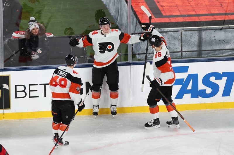 Feb 17, 2024; East Rutherford, New Jersey, USA; Philadelphia Flyers right wing Owen Tippett (74) celebrates his goal with teammates during the second period in a Stadium Series ice hockey game against the New Jersey Devils at MetLife Stadium. Mandatory Credit: Vincent Carchietta-USA TODAY Sports