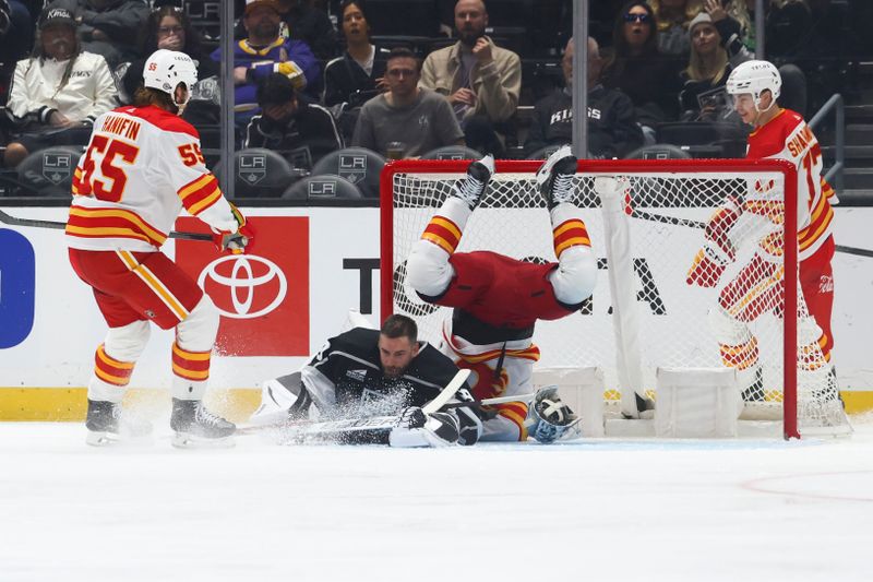 Dec 23, 2023; Los Angeles, California, USA; Calgary Flames center Blake Coleman (20) falls over Los Angeles Kings goaltender Cam Talbot (39) after scoring a goal during the second period of a game at Crypto.com Arena. Mandatory Credit: Jessica Alcheh-USA TODAY Sports