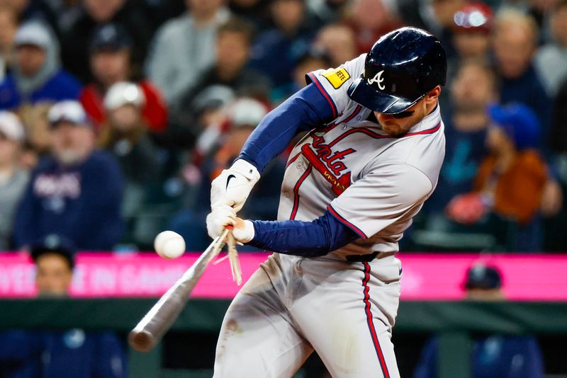 Apr 30, 2024; Seattle, Washington, USA; Atlanta Braves left fielder Jarred Kelenic (24) breaks his bat on a single against the Seattle Mariners during the eighth inning at T-Mobile Park. Mandatory Credit: Joe Nicholson-USA TODAY Sports