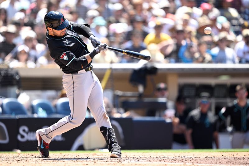 Jul 7, 2024; San Diego, California, USA; Arizona Diamondbacks third baseman Eugenio Suarez (28) hits a two-run home run against the San Diego Padres during the seventh inning at Petco Park. Mandatory Credit: Orlando Ramirez-USA TODAY Sports