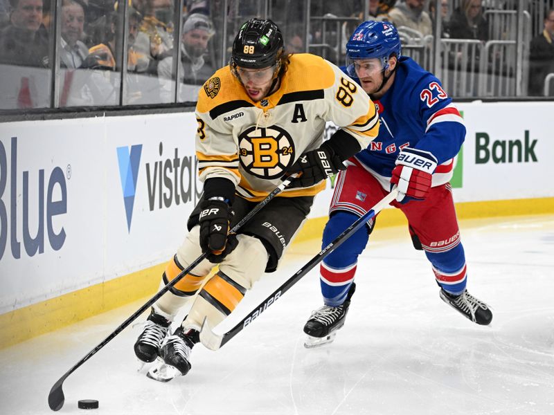 Mar 21, 2024; Boston, Massachusetts, USA; Boston Bruins right wing David Pastrnak (88) controls the puck against New York Rangers defenseman Adam Fox (23) during the first period at the TD Garden. Mandatory Credit: Brian Fluharty-USA TODAY Sports