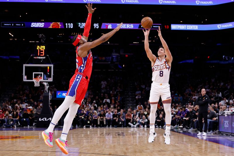 PHOENIX, ARIZONA - MARCH 20: Grayson Allen #8 of the Phoenix Suns shoots from the three-point line against Ricky Council IV #16 of the Philadelphia 76ers during the second half at Footprint Center on March 20, 2024 in Phoenix, Arizona. NOTE TO USER: User expressly acknowledges and agrees that, by downloading and or using this photograph, User is consenting to the terms and conditions of the Getty Images License Agreement.  (Photo by Chris Coduto/Getty Images)