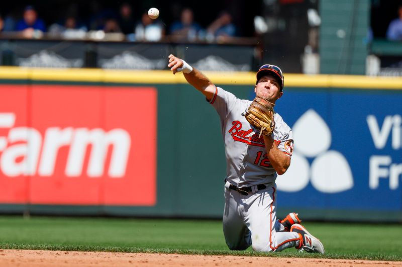 Aug 13, 2023; Seattle, Washington, USA; Baltimore Orioles second baseman Adam Frazier (12) throws to first base for a groundout against the Seattle Mariners during the second inning at T-Mobile Park. Mandatory Credit: Joe Nicholson-USA TODAY Sports