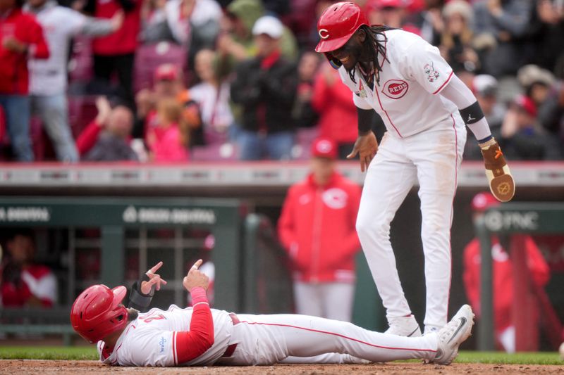 April 21, 2024; Cincinnati, Ohio, USA;  Cincinnati Reds designated hitter Nick Martini (23) and Cincinnati Reds shortstop Elly De La Cruz (44), who both scored on a double by Cincinnati Reds first base Christian Encarnacion-Strand (33) (not pictured), react in the sixth inning of a baseball game against the Los Angeles Angels at Great American Ball Park. Mandatory Credit: Kareem Elgazzar/USA TODAY Sports via The Cincinnati Enquirer

