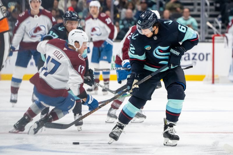 Oct 22, 2024; Seattle, Washington, USA;  Seattle Kraken defenseman Brandon Montour (62) skates with the puck as forward Jaden Schwartz (17) checks Colorado Avalanche forward Parker Kelly (17) during the third period at Climate Pledge Arena. Mandatory Credit: Stephen Brashear-Imagn Images