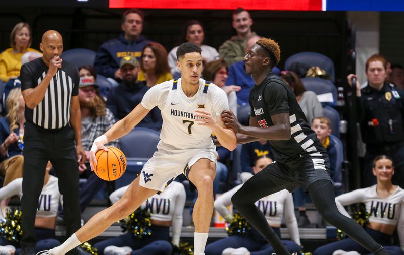 Jan 31, 2024; Morgantown, West Virginia, USA; West Virginia Mountaineers center Jesse Edwards (7) backs down against Cincinnati Bearcats forward Aziz Bandaogo (55) during the first half at WVU Coliseum. Mandatory Credit: Ben Queen-USA TODAY Sports