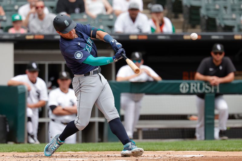 Jul 28, 2024; Chicago, Illinois, USA; Seattle Mariners shortstop Dylan Moore (25) doubles against the Chicago White Sox during the second inning at Guaranteed Rate Field. Mandatory Credit: Kamil Krzaczynski-USA TODAY Sports