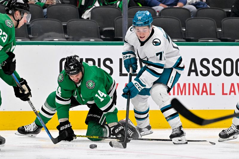 Nov 20, 2024; Dallas, Texas, USA; San Jose Sharks center Macklin Celebrini (71) skates with the puck past Dallas Stars left wing Jamie Benn (14) during the third period at the American Airlines Center. Mandatory Credit: Jerome Miron-Imagn Images