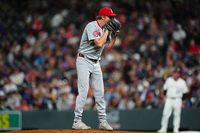 Sep 25, 2024; Denver, Colorado, USA; St. Louis Cardinals starting pitcher Erick Fedde (12) prepares to pitch in the fifth inning against the Colorado Rockies at Coors Field. Mandatory Credit: Ron Chenoy-Imagn Images