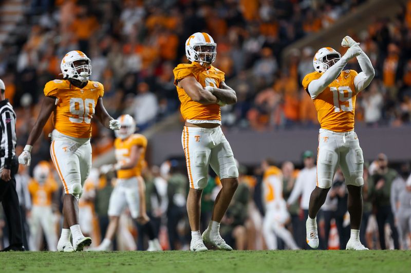 Nov 25, 2023; Knoxville, Tennessee, USA; Tennessee Volunteers defensive lineman Dominic Bailey (90) and defensive lineman Tyler Baron (9) and defensive lineman Joshua Josephs (19) celebrate after a sack against the Vanderbilt Commodores during the second half at Neyland Stadium. Mandatory Credit: Randy Sartin-USA TODAY Sports
