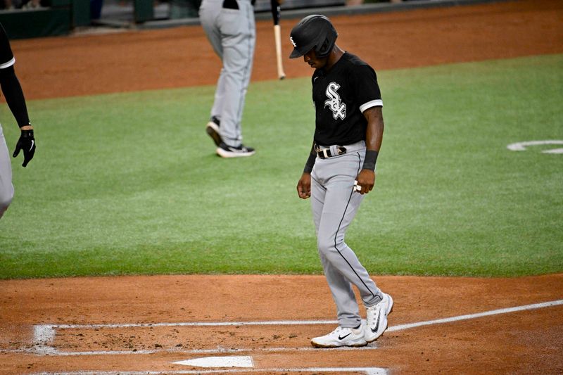 Aug 3, 2023; Arlington, Texas, USA; Chicago White Sox shortstop Tim Anderson (7) scores a run on a walk given up by Texas Rangers starting pitcher Max Scherzer (31) during the first inning at Globe Life Field. Mandatory Credit: Jerome Miron-USA TODAY Sports