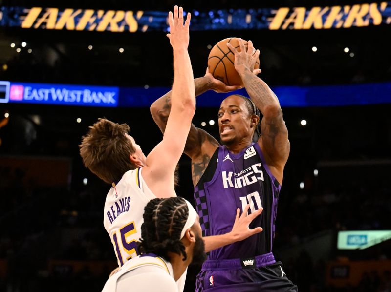 LOS ANGELES, CALIFORNIA - OCTOBER 26: DeMar DeRozan #10 of the Sacramento Kings passes the ball over Austin Reaves #15 of the Los Angeles Lakers in the first half at Crypto.com Arena on October 26, 2024 in Los Angeles, California. NOTE TO USER: User expressly acknowledges and agrees that, by downloading and or using this photograph, User is consenting to the terms and conditions of the Getty Images License Agreement. (Photo by John McCoy/Getty Images)