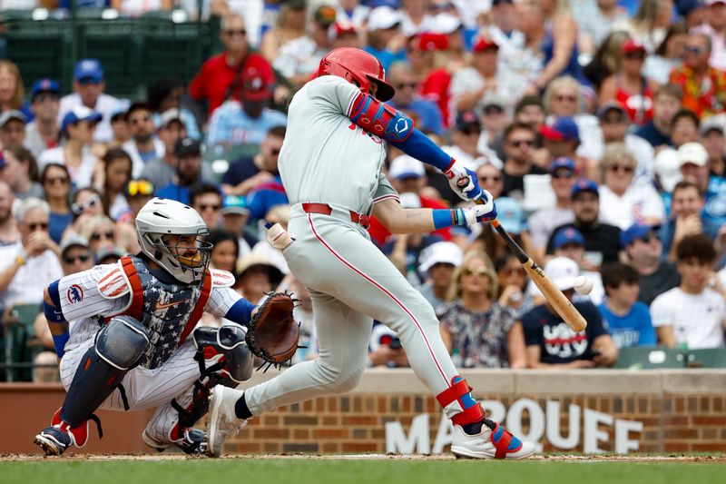 Jul 4, 2024; Chicago, Illinois, USA; Philadelphia Phillies outfielder Brandon Marsh (16) hits an RBI-single against the Chicago Cubs during the first inning at Wrigley Field. Mandatory Credit: Kamil Krzaczynski-USA TODAY Sports