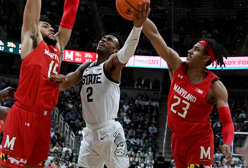 Feb 7, 2023; East Lansing, Michigan, USA;  Michigan State Spartans guard Tyson Walker (2) splits Maryland Terrapins guard Ian Martinez (23) and forward Patrick Emilien (15) for a shot in the second half at Jack Breslin Student Events Center. Mandatory Credit: Dale Young-USA TODAY Sports