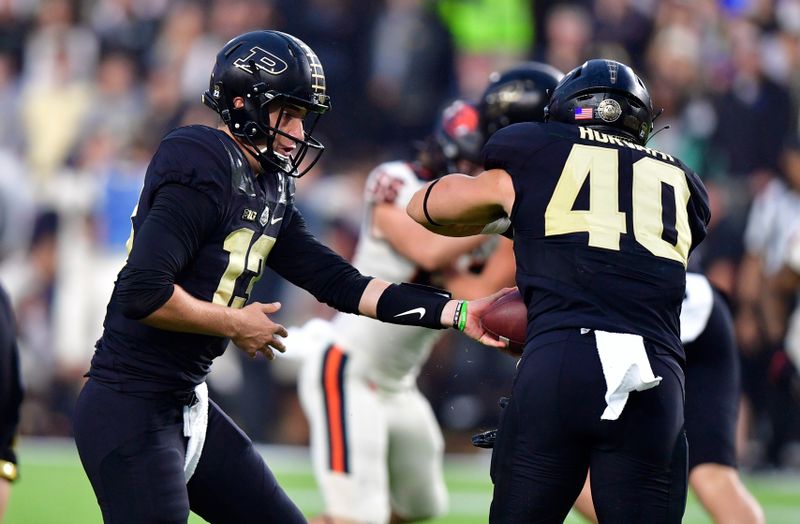 Sep 4, 2021; West Lafayette, Indiana, USA;  Purdue Boilermakers quarterback Jack Plummer (13) hands the ball off to Purdue Boilermakers running back Zander Horvath (40) during the first quarter of the game against the Oregon State Beavers at Ross-Ade Stadium. Mandatory Credit: Marc Lebryk-USA TODAY Sports