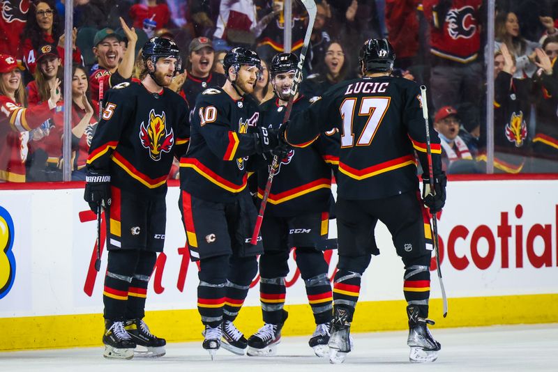 Jan 21, 2023; Calgary, Alberta, CAN; Calgary Flames center Jonathan Huberdeau (10) celebrates his goal with teammates against the Tampa Bay Lightning during the third period at Scotiabank Saddledome. Mandatory Credit: Sergei Belski-USA TODAY Sports