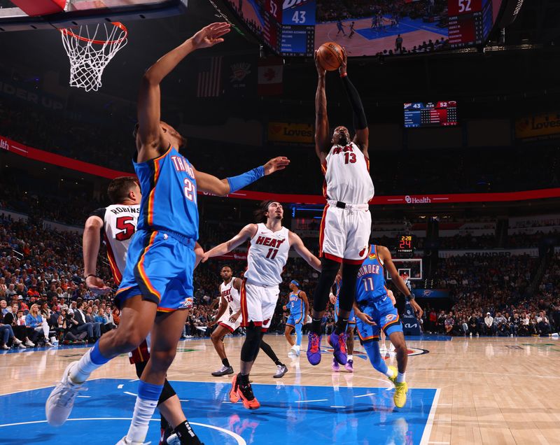 OKLAHOMA CITY, OK - MARCH 8:  Bam Adebayo #13 of the Miami Heat grabs a rebound during the game against the Oklahoma City Thunder on March 8, 2024 at Paycom Arena in Oklahoma City, Oklahoma. NOTE TO USER: User expressly acknowledges and agrees that, by downloading and or using this photograph, User is consenting to the terms and conditions of the Getty Images License Agreement. Mandatory Copyright Notice: Copyright 2024 NBAE (Photo by Zach Beeker/NBAE via Getty Images)