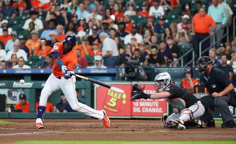 Jun 21, 2024; Houston, Texas, USA; Houston Astros designated hitter Yordan Alvarez (44) hits a sacrifice RBI against the Baltimore Orioles in the first inning at Minute Maid Park. Mandatory Credit: Thomas Shea-USA TODAY Sports