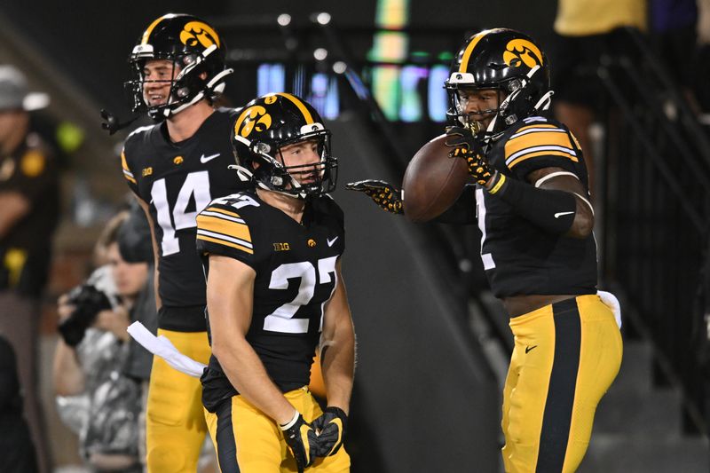 Sep 17, 2022; Iowa City, Iowa, USA; Iowa Hawkeyes running back Kaleb Johnson (2) celebrates with wide receiver Jack Johnson (27) and wide receiver Brody Brecht (14) after running for a touchdown against the Nevada Wolf Pack during the fourth quarter at Kinnick Stadium. Mandatory Credit: Jeffrey Becker-USA TODAY Sports